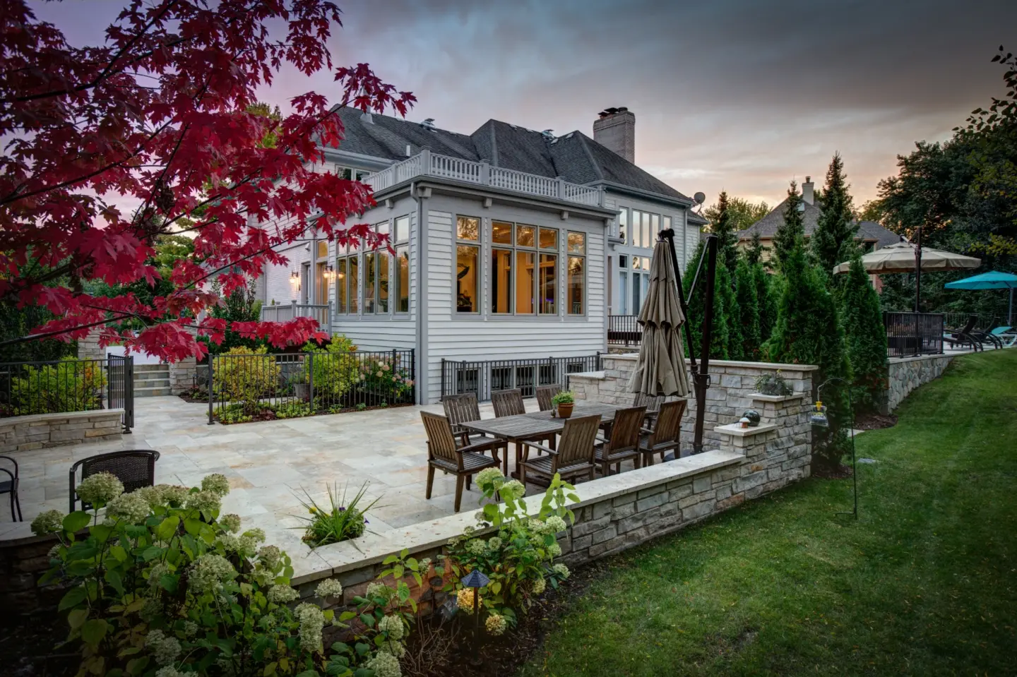 01 beautiful glowing sunroom with patio and landscaping