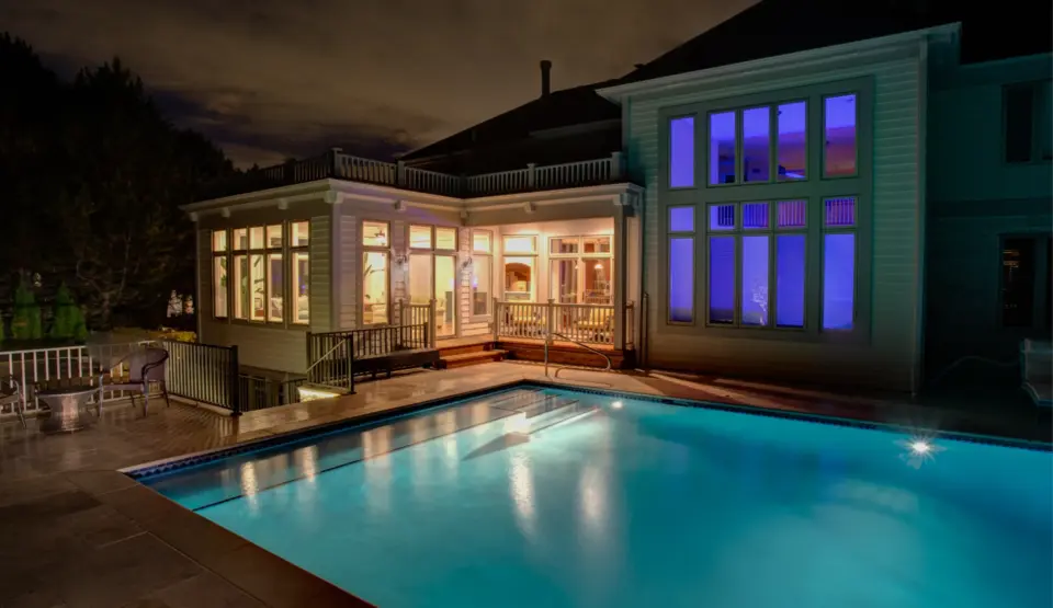 02 beautiful glowing sunroom next to pool at night