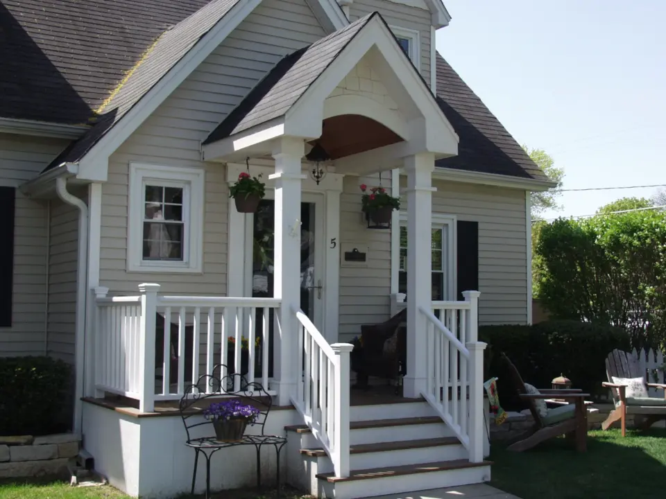 04 white portico front entrace with hanging flower baskets
