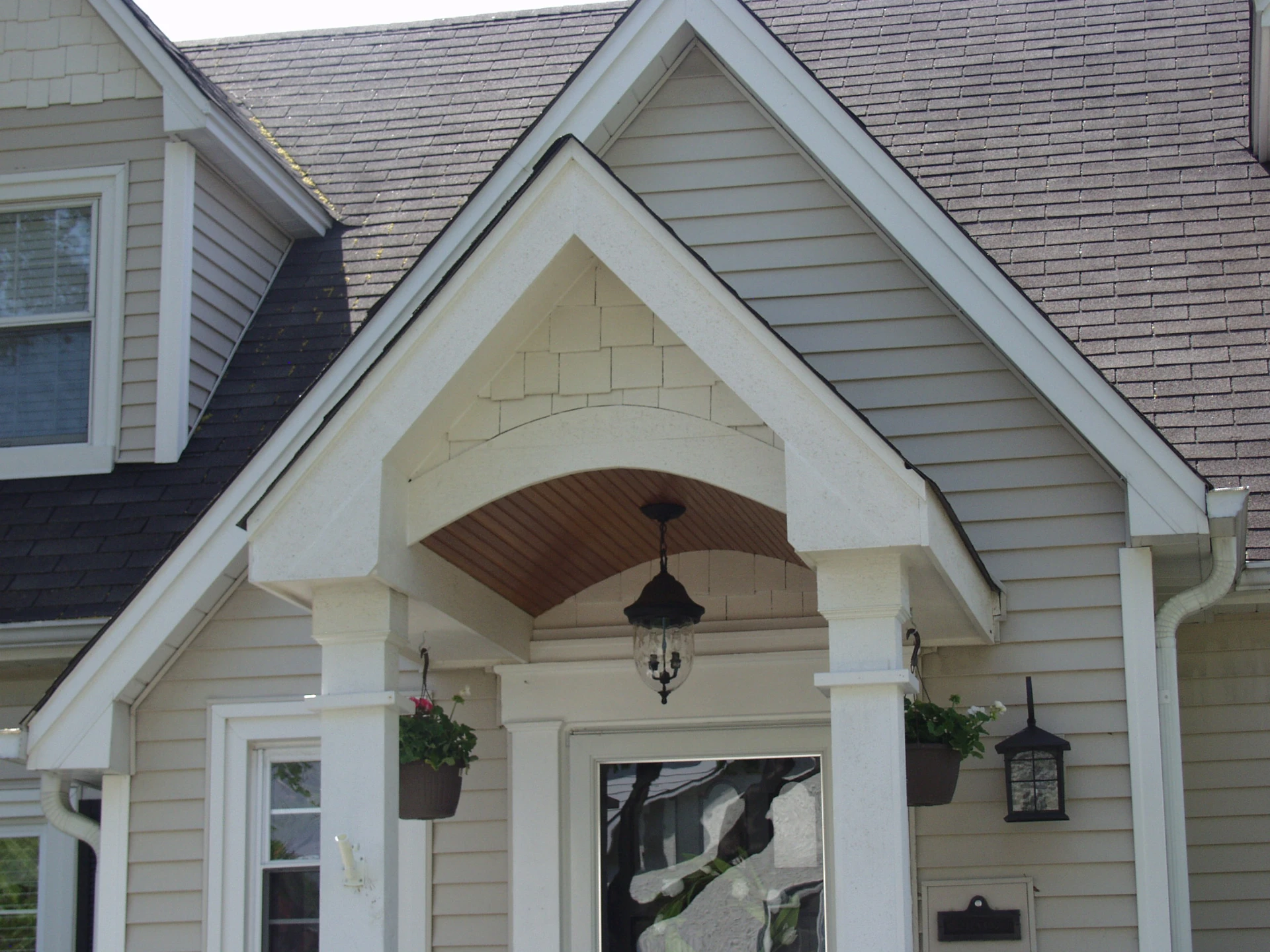 06 white portico front entrace with hanging flower baskets