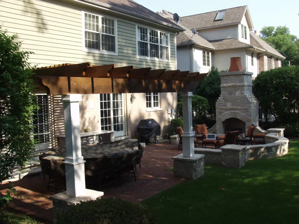 10 rough sawn pergola alongside a stone fireplace