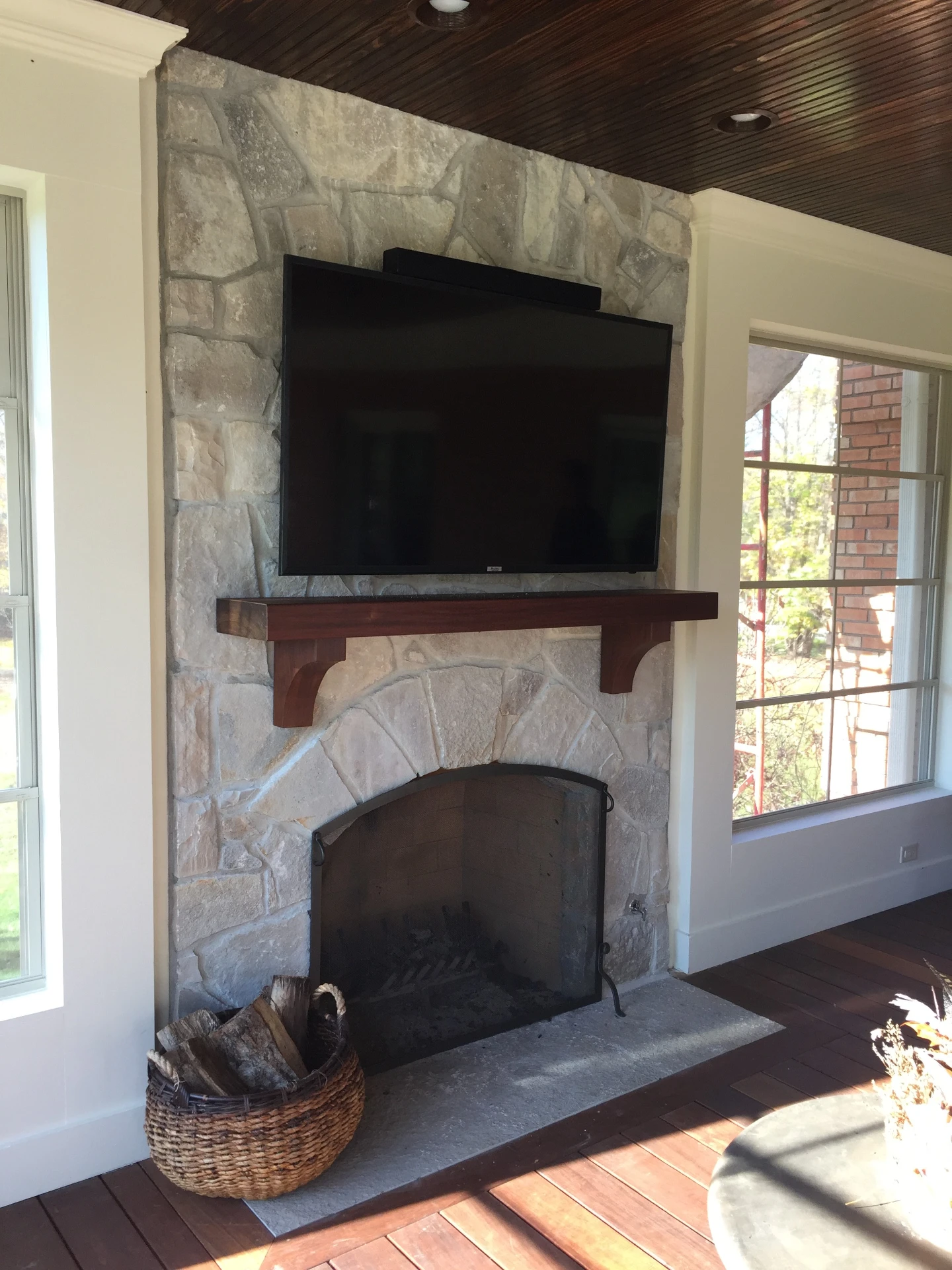 16 stone fireplace and television inside of 3 season room