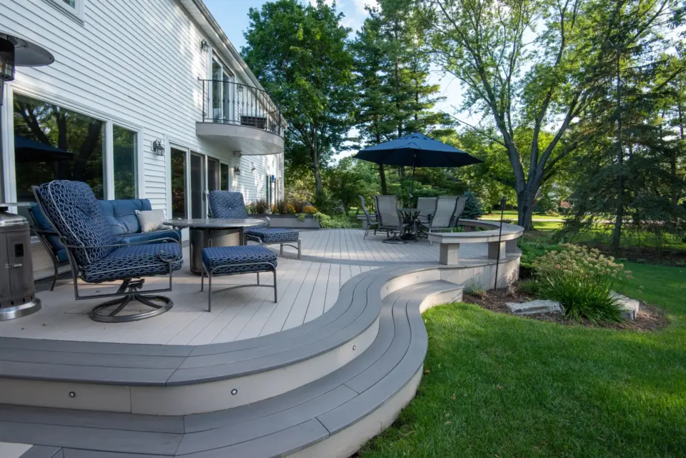 19 TimberTech Slate Gray and Castle Gate cellular pvc deck with patio table and curved boards stairs and bench