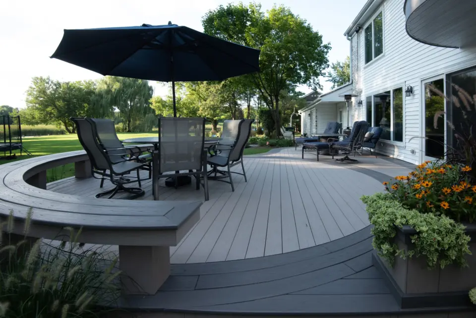 20 TimberTech Slate Gray and Castle Gate cellular pvc deck with patio table and curved boards stairs and bench
