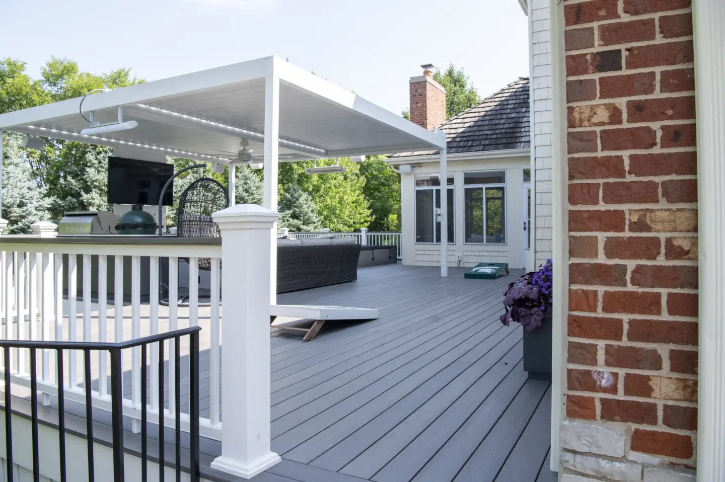 22 white aluminum Corradi Alba pergola above outdoor kitchen and TimberTech Castle Gate cellular pvc deck