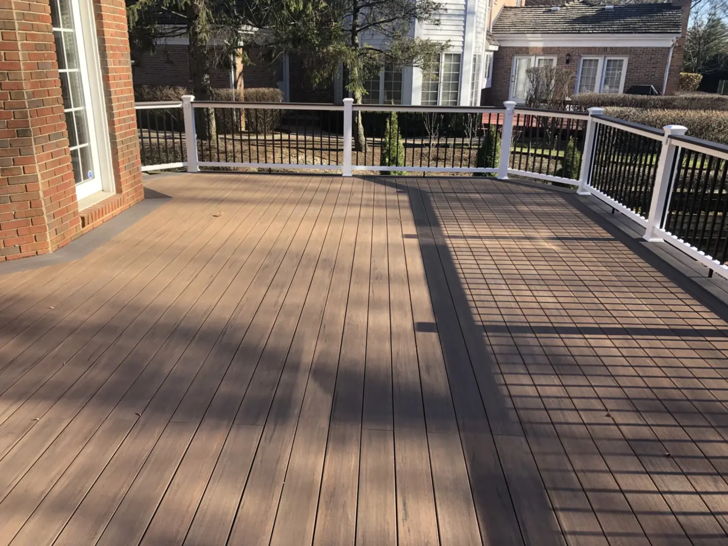 25 brown pvc deck with white Azek cellular PVC and dark gray drink rail