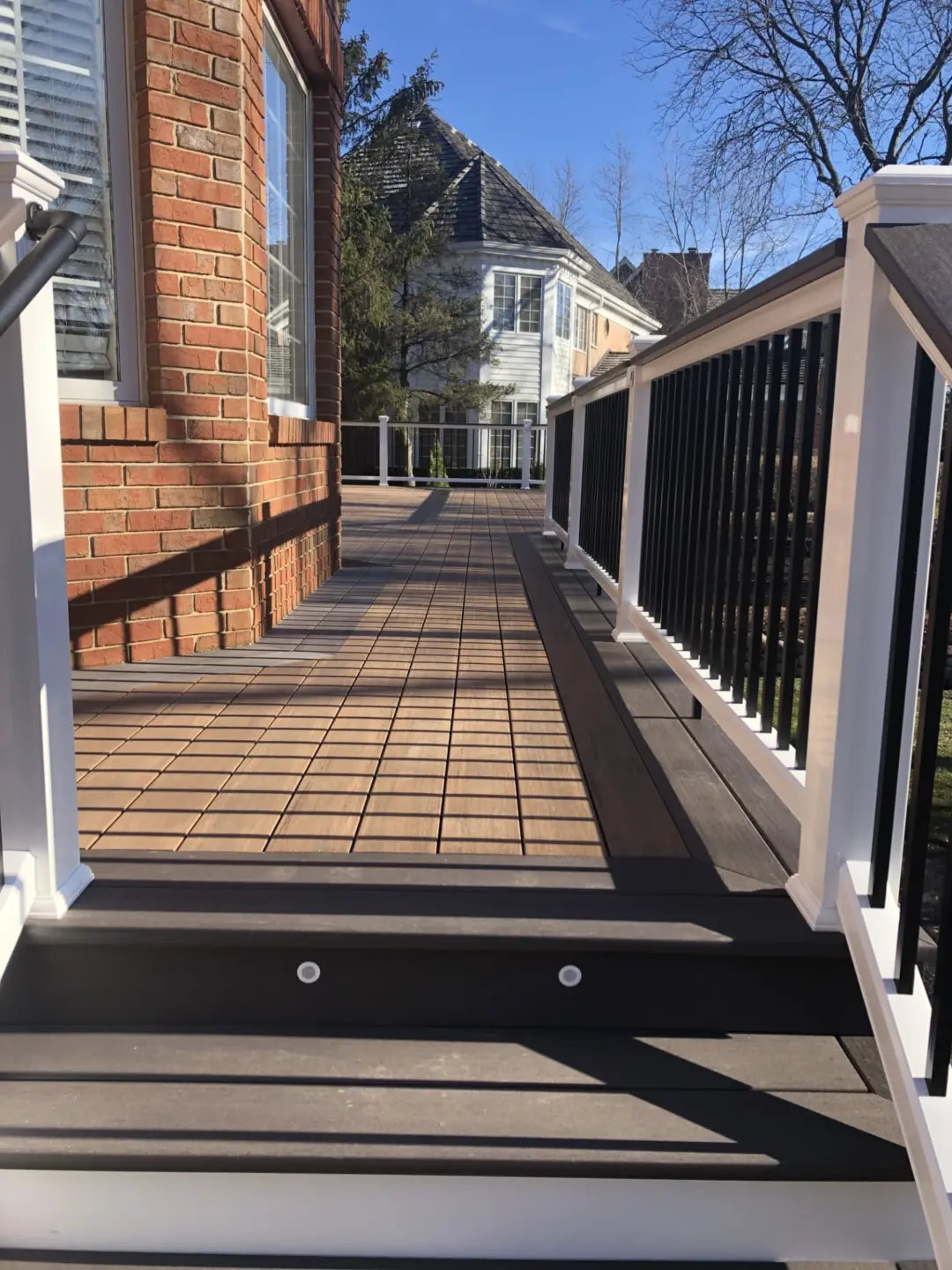 26 brown pvc deck with white Azek cellular PVC and dark gray drink rail
