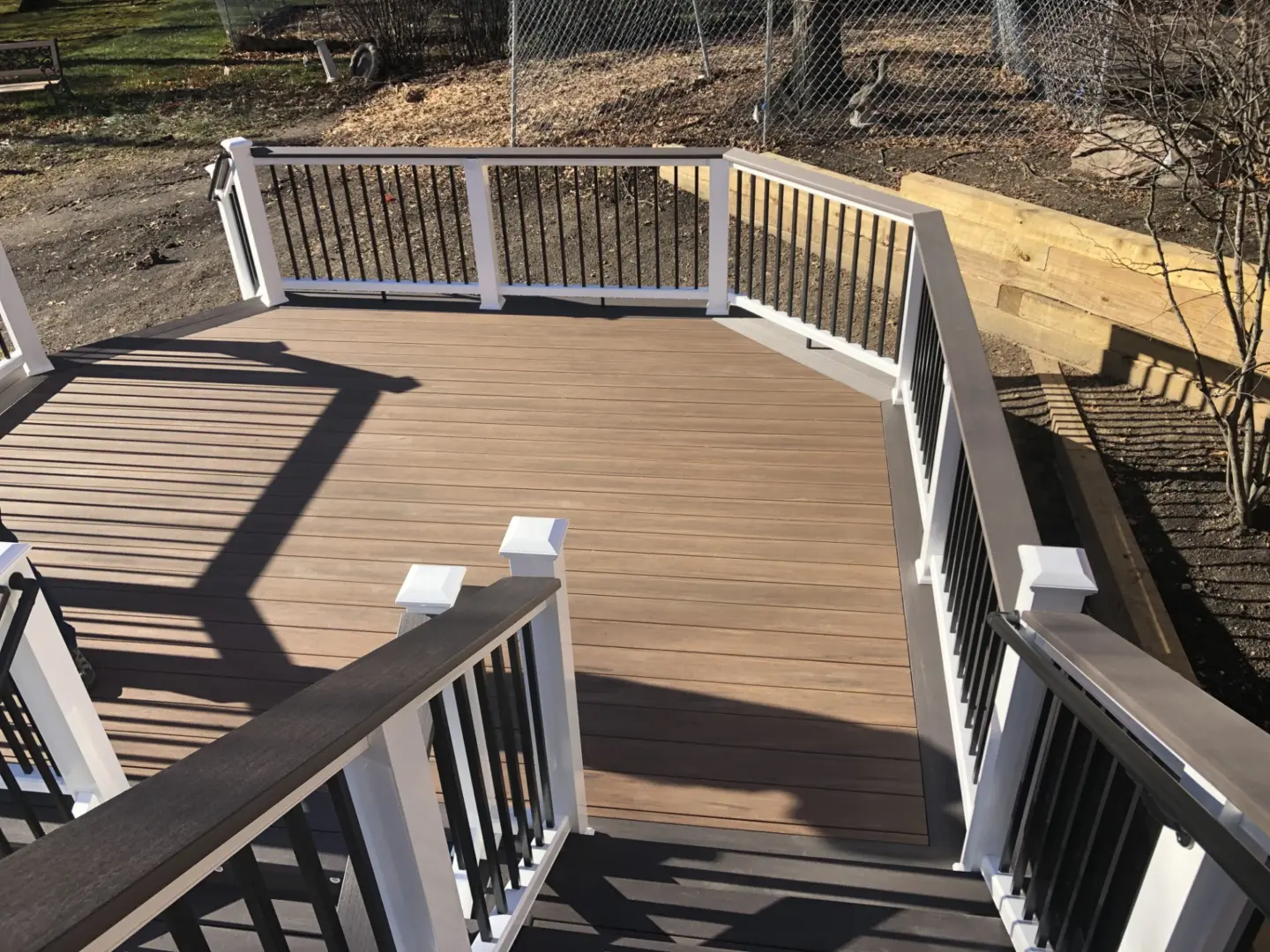 27 brown pvc deck with white Azek cellular PVC and dark gray drink rail