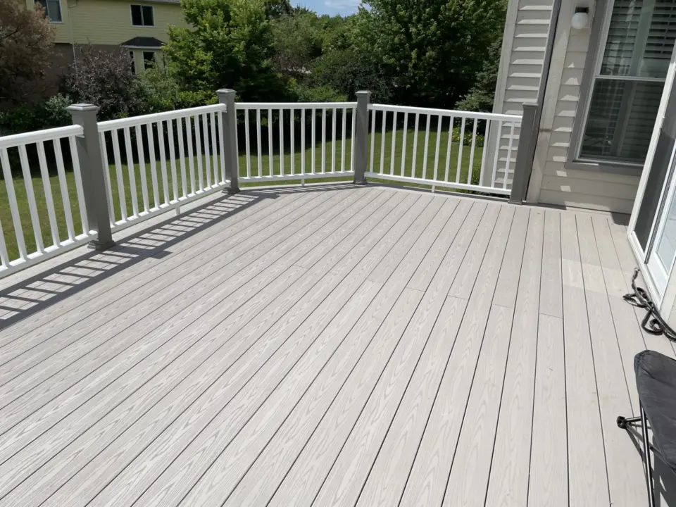 62 TimberTech Slate Gray cellular pvc deck with Trex Gravel Path railing posts and white TimberTech Radiance Express rail sections